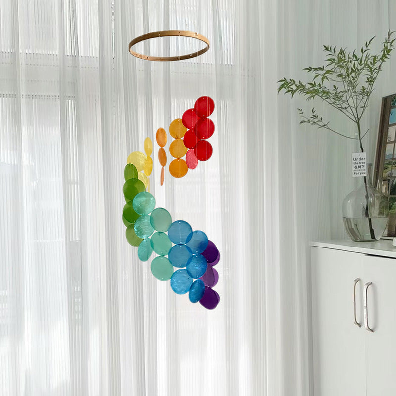 Bohemian seashell wind chime with multicolor circular shells hanging in clusters