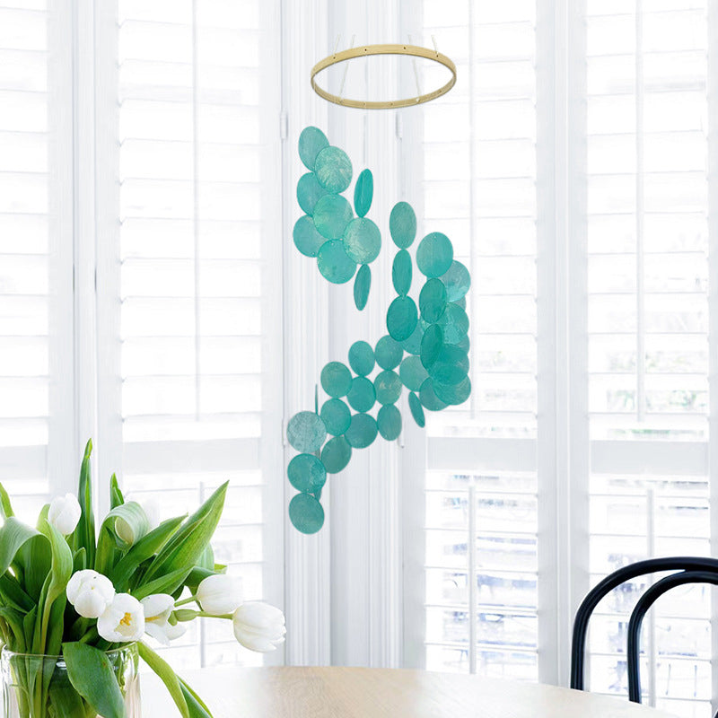 Bohemian seashell wind chime with teal and green circular shells hanging from ring