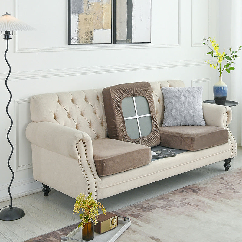 Beige sofa cover set with fitted front panel and arm sections over a sofa