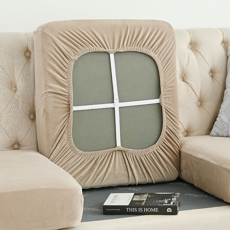 Beige sofa cover with elastic ruched trim around a window-style back panel