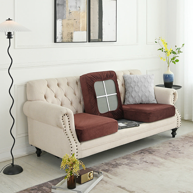 Burgundy sofa cover with elastic front panel and tufted-look border
