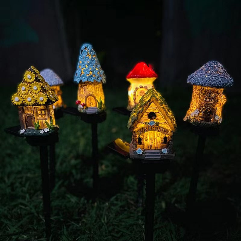 Illuminated solar garden house stake lights with yellow walls and blue roofs