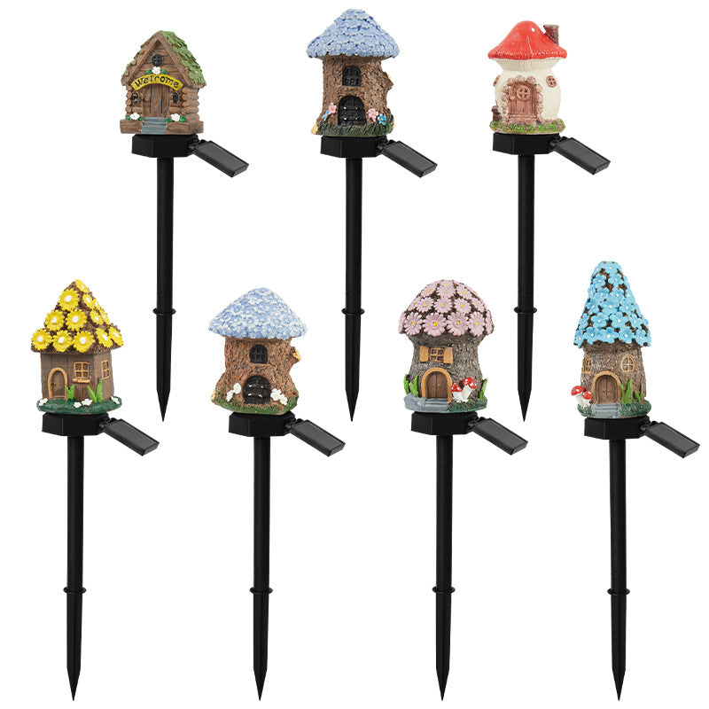 Assorted solar garden stake lights with colorful resin house tops and black stakes