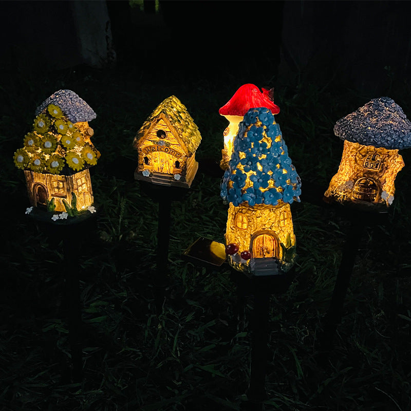 Glowing solar garden stake lights with glittery resin houses in yellow and blue
