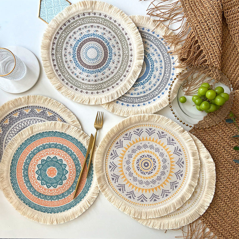 Round placemats with fringed edges, featuring blue, teal, and tan circular mandala designs
