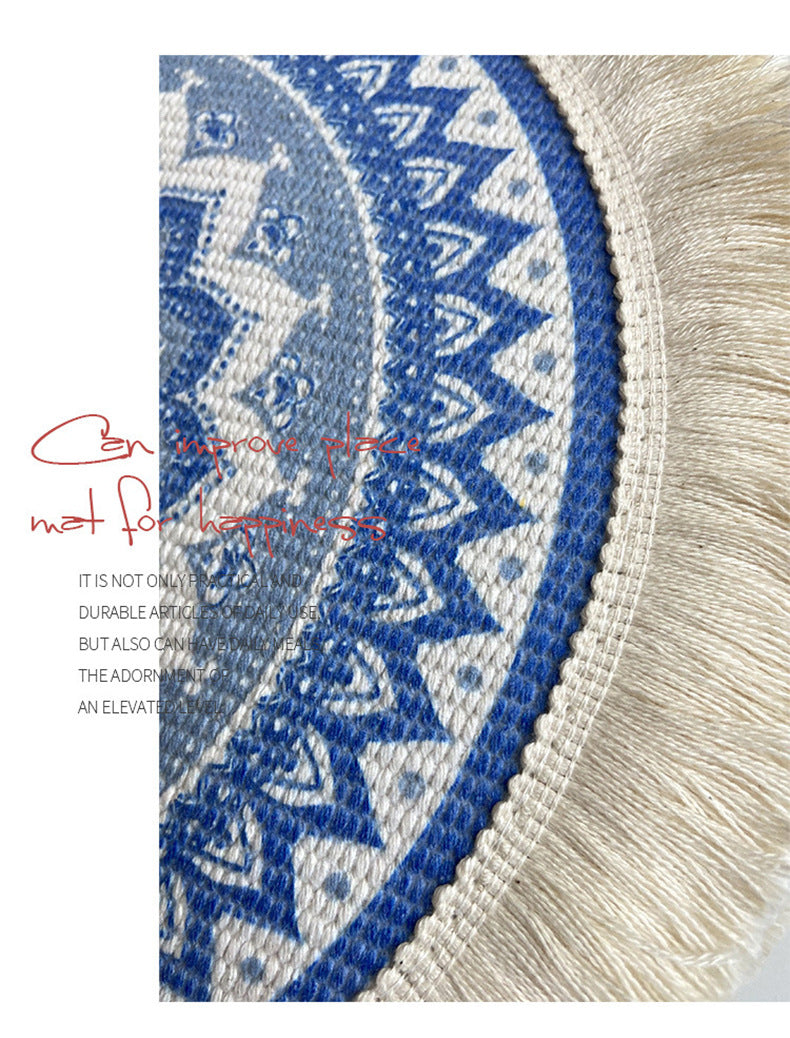 Close-up of woven placemat edge with tassel fringe and blue geometric embroidery