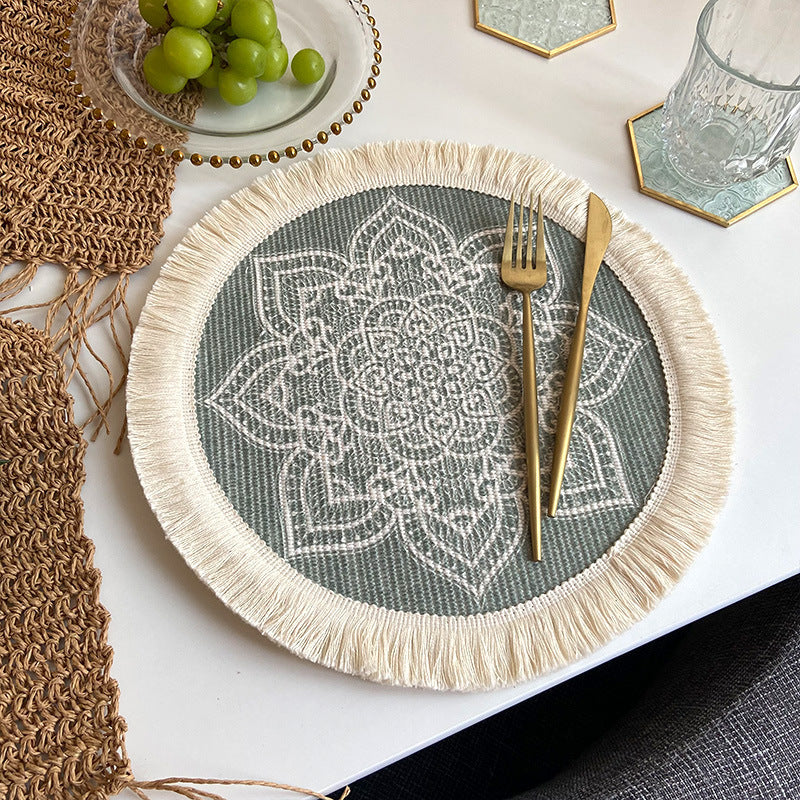 Round woven cotton placemat, grey geometric print with cream fringe tassels