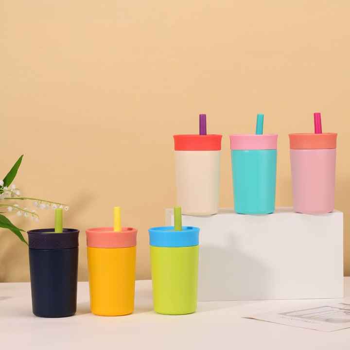 Set of insulated tumblers with straws in assorted colors on a white stand.