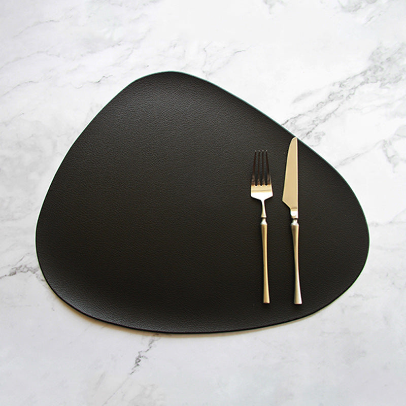 Black triangular PVC leather placemat with fork and knife on top