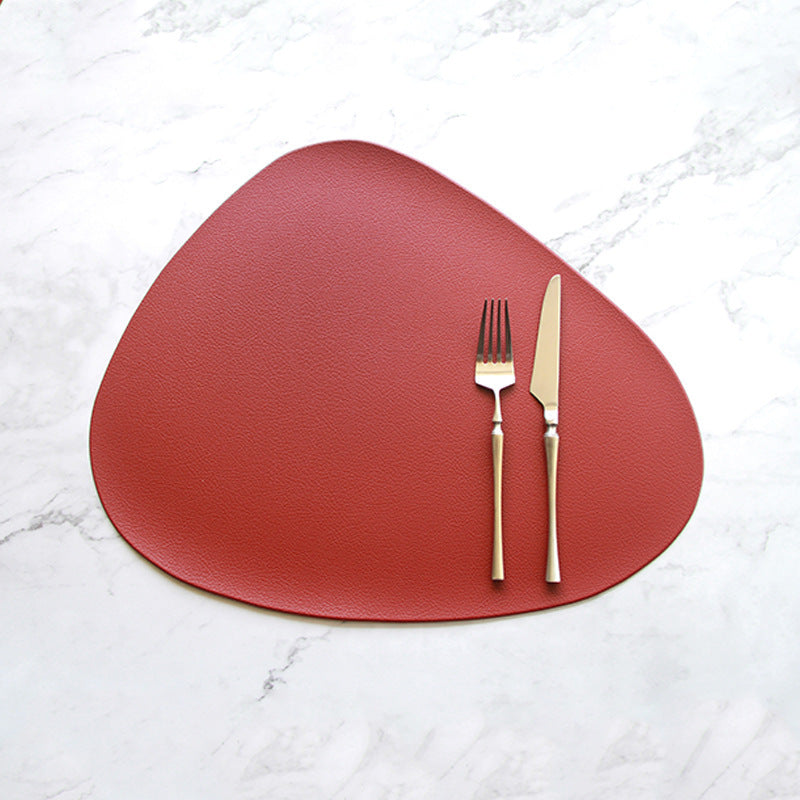 Red triangular PVC placemat with fork and knife centered on top