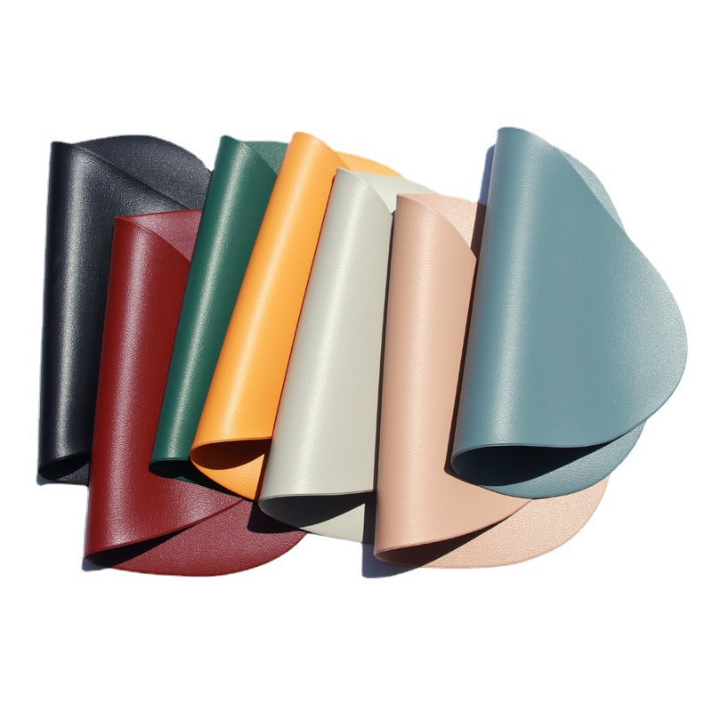 Set of triangular placemats stacked in black, red, green, orange, white, and beige