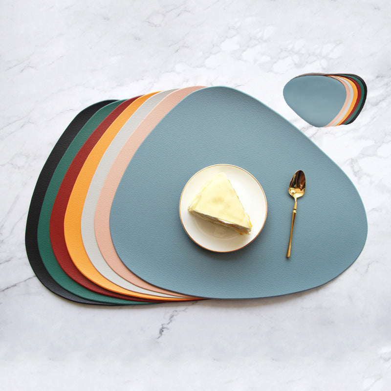 Triangular placemats layered in teal, blue, and multicolor stripes with plate and fork