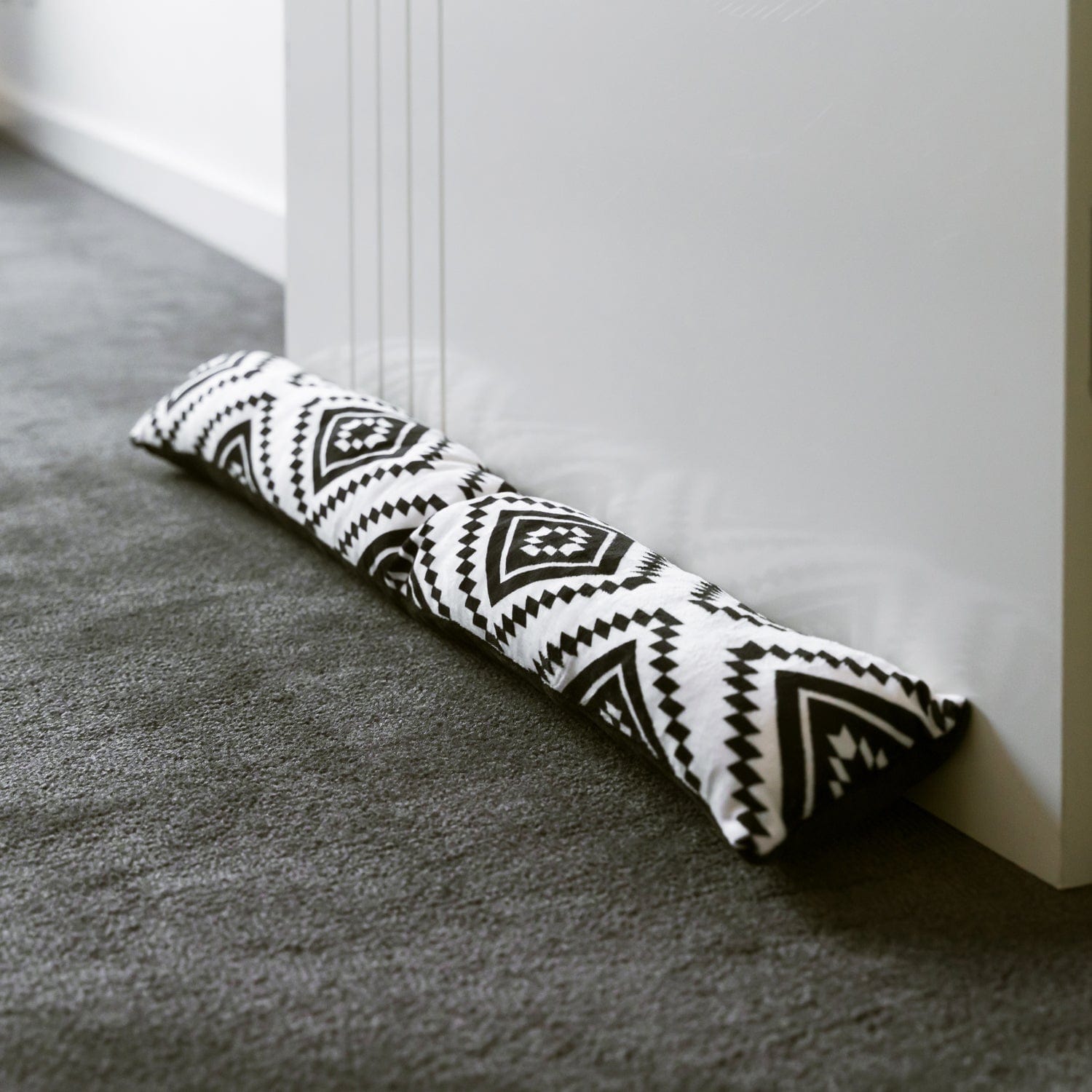 Geometric print draft door stopper, white with black zigzag and diamond shapes