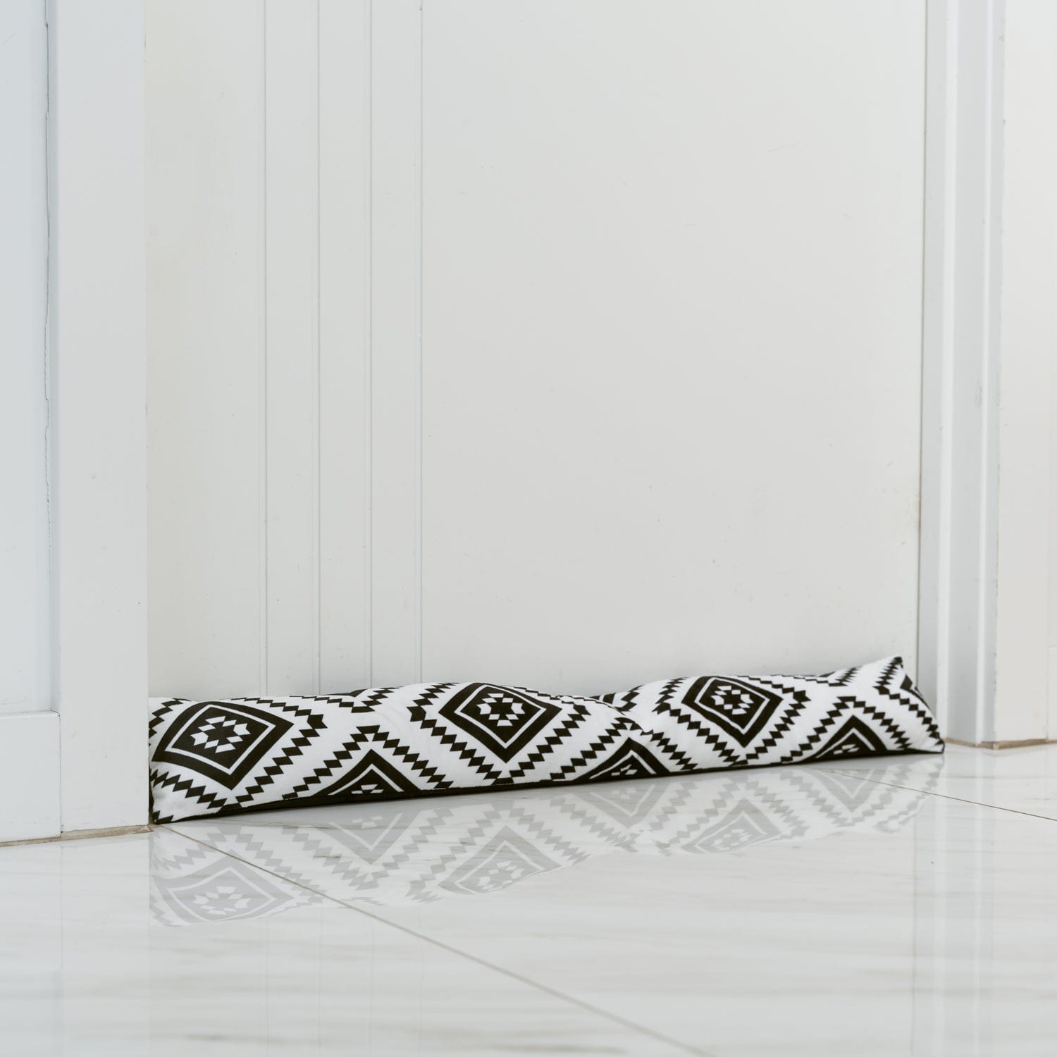 Chevron and diamond patterned draft stopper for doors, white with black print