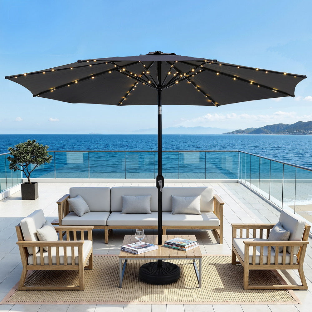 Charcoal market umbrella with LED string lights along canopy ribs