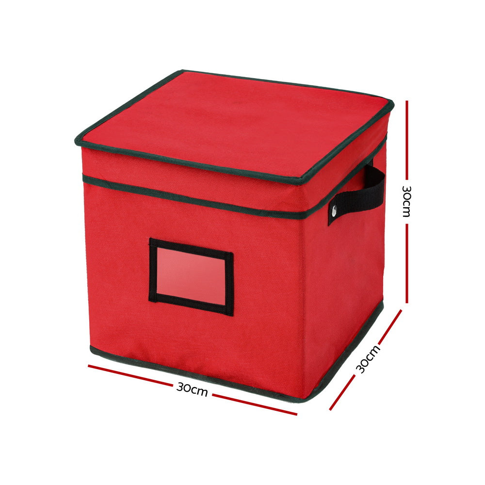 Red fabric storage box with green piping, hinged lid, and black pull handle