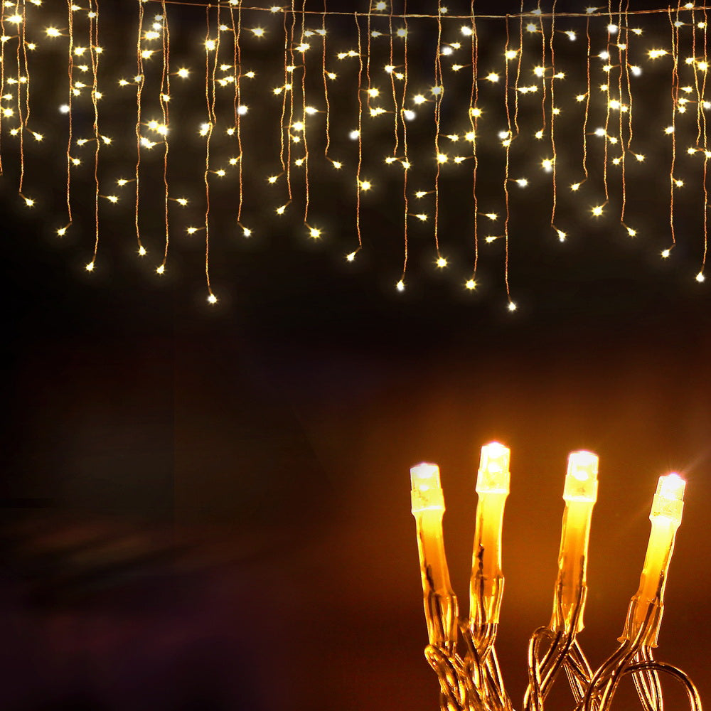 Warm white LED icicle string lights with bright hanging bulbs close-up