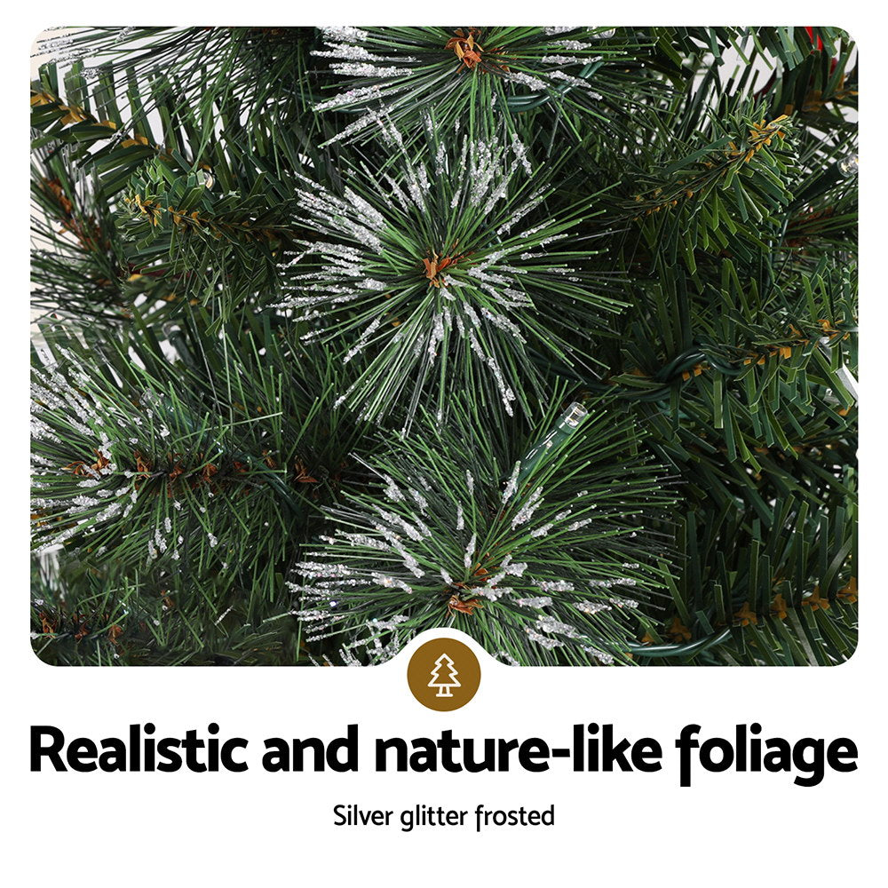Silver glitter-frosted Christmas tree branches with warm white LED lights