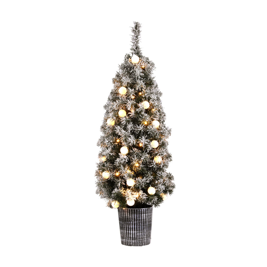 Potted snowy Christmas tree with warm white globe lights and frosted branches