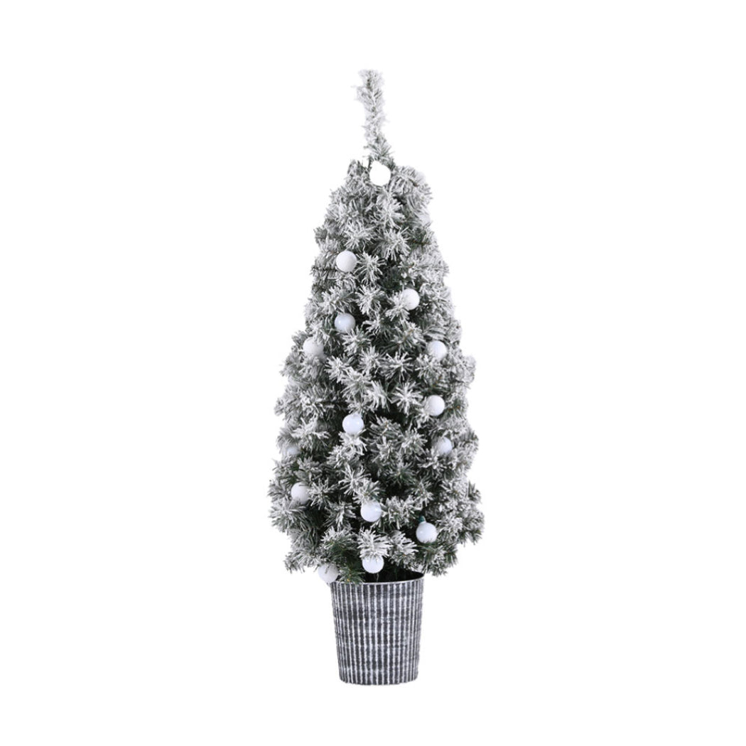 Potted snowy Christmas tree with frosted branches and white bauble ornaments