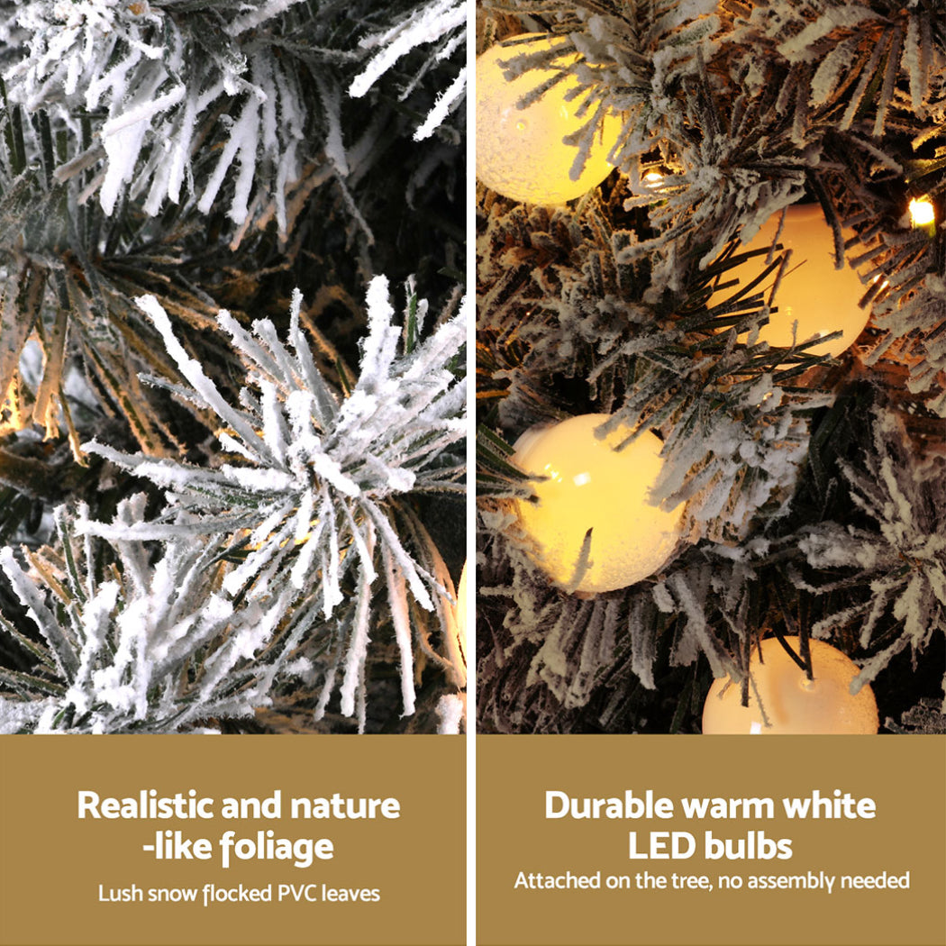 Frosted Christmas tree foliage with warm white LED bulbs and white ornaments
