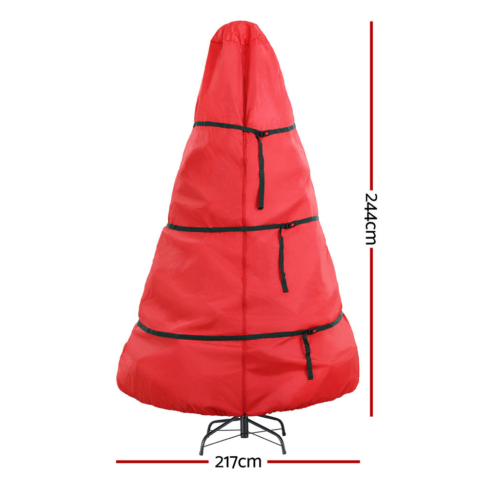 Red Christmas tree storage bag with black strap bands and zipper, with hanging cinch cords.