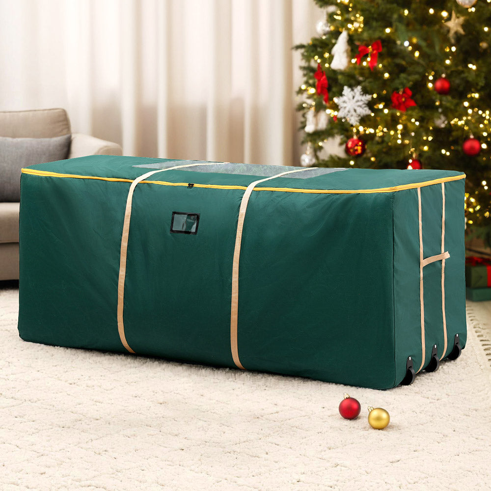 Green Christmas tree storage bag with top handles and corner wheels for transport.