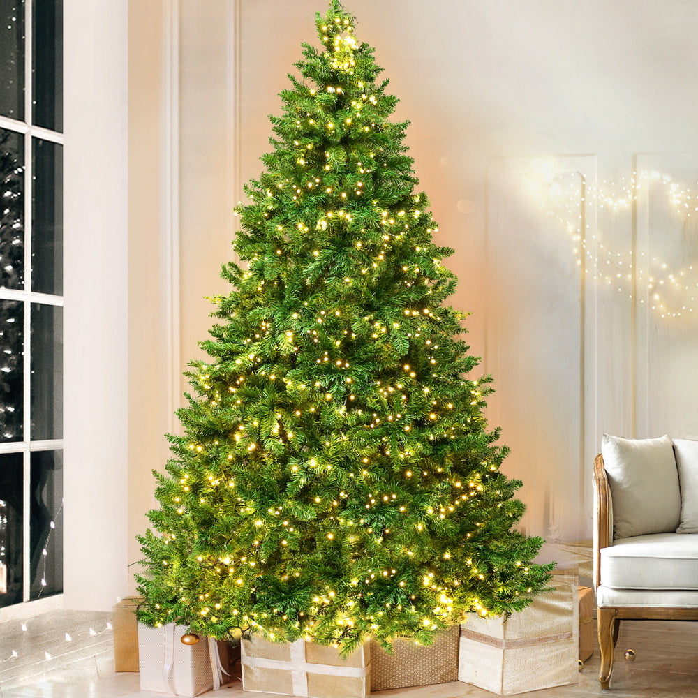 LED pre-lit Christmas tree with dark green branches and warm yellow lights, full view