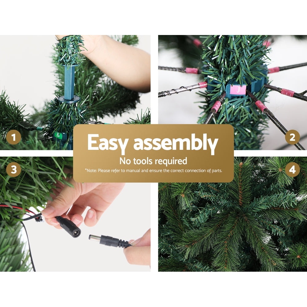 Christmas tree decoration assembly, hands connect multi-colour light leads to green branches
