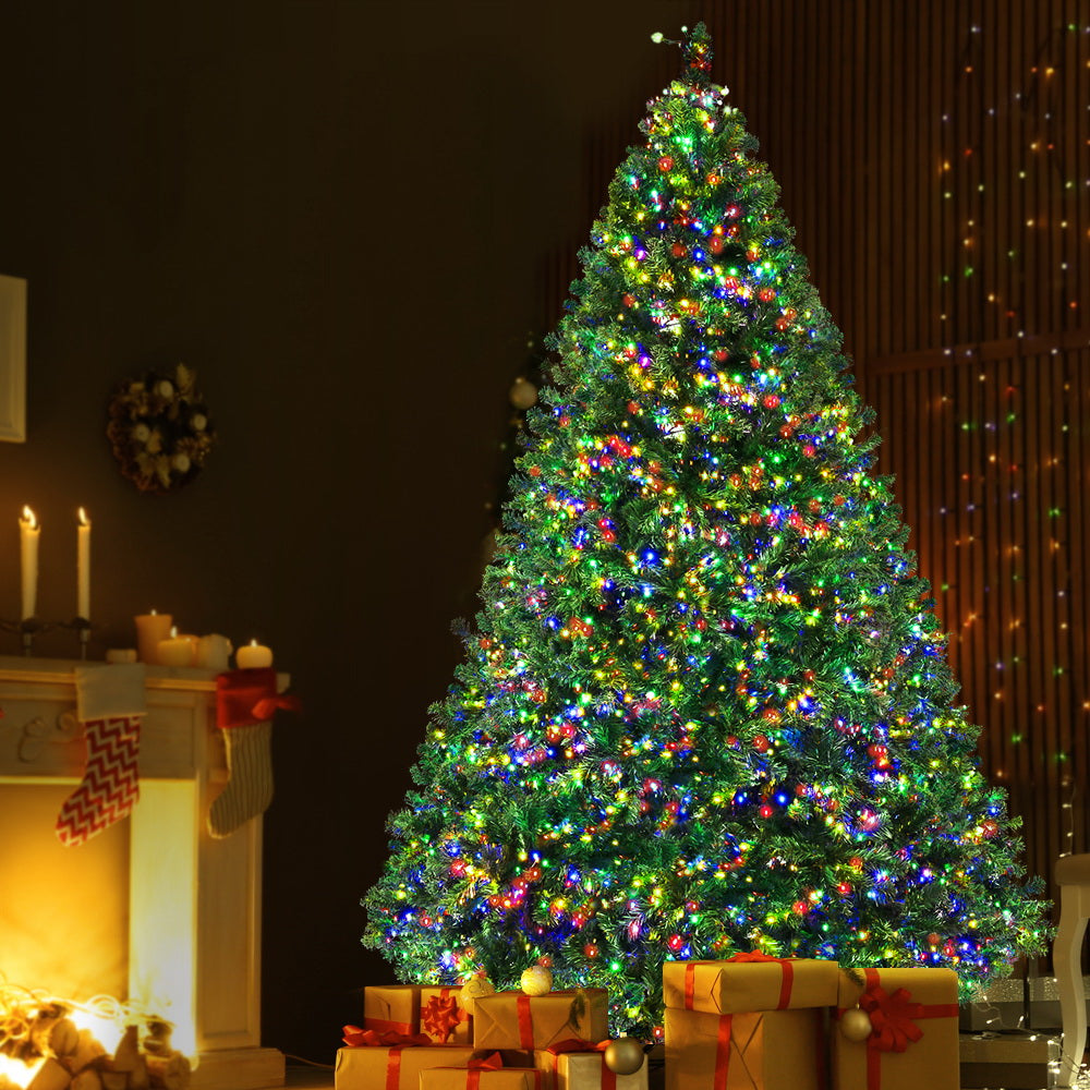 Pre-lit Christmas tree decoration with green foliage and multi-colour lights, full height view