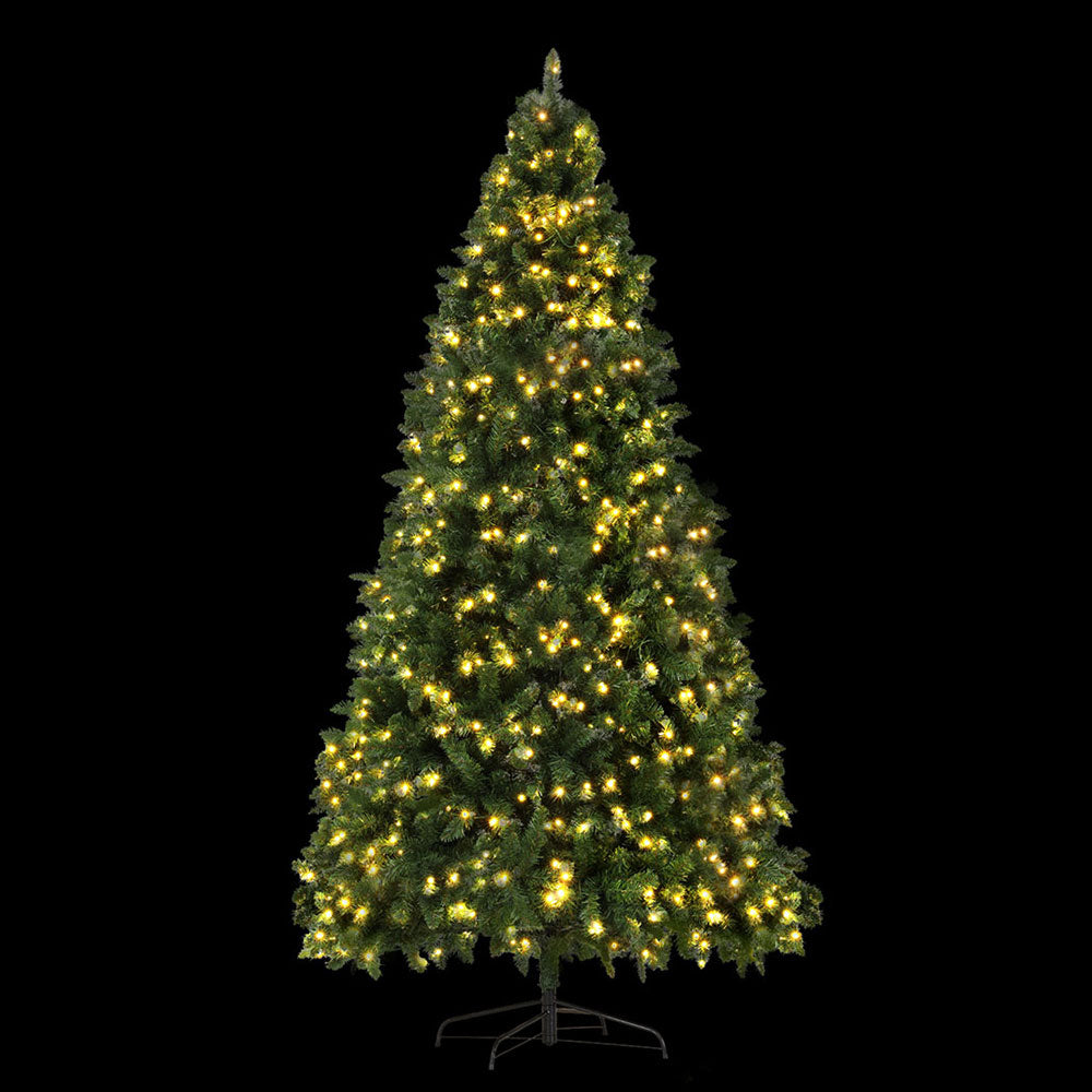 Prelit artificial Christmas tree with dense green foliage and warm yellow LED lights