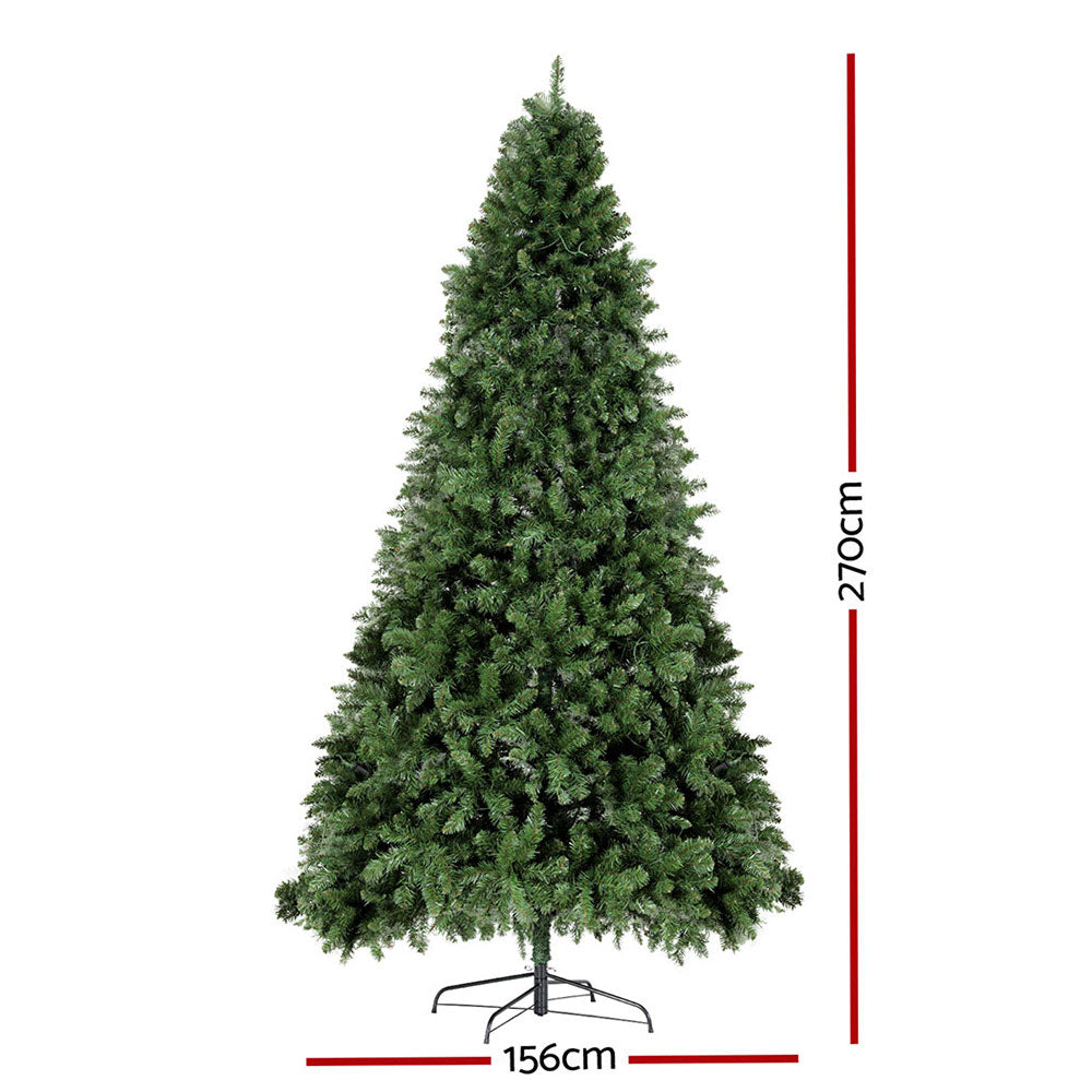 Artificial Christmas tree with green tips, warm yellow LED lights, on metal stand