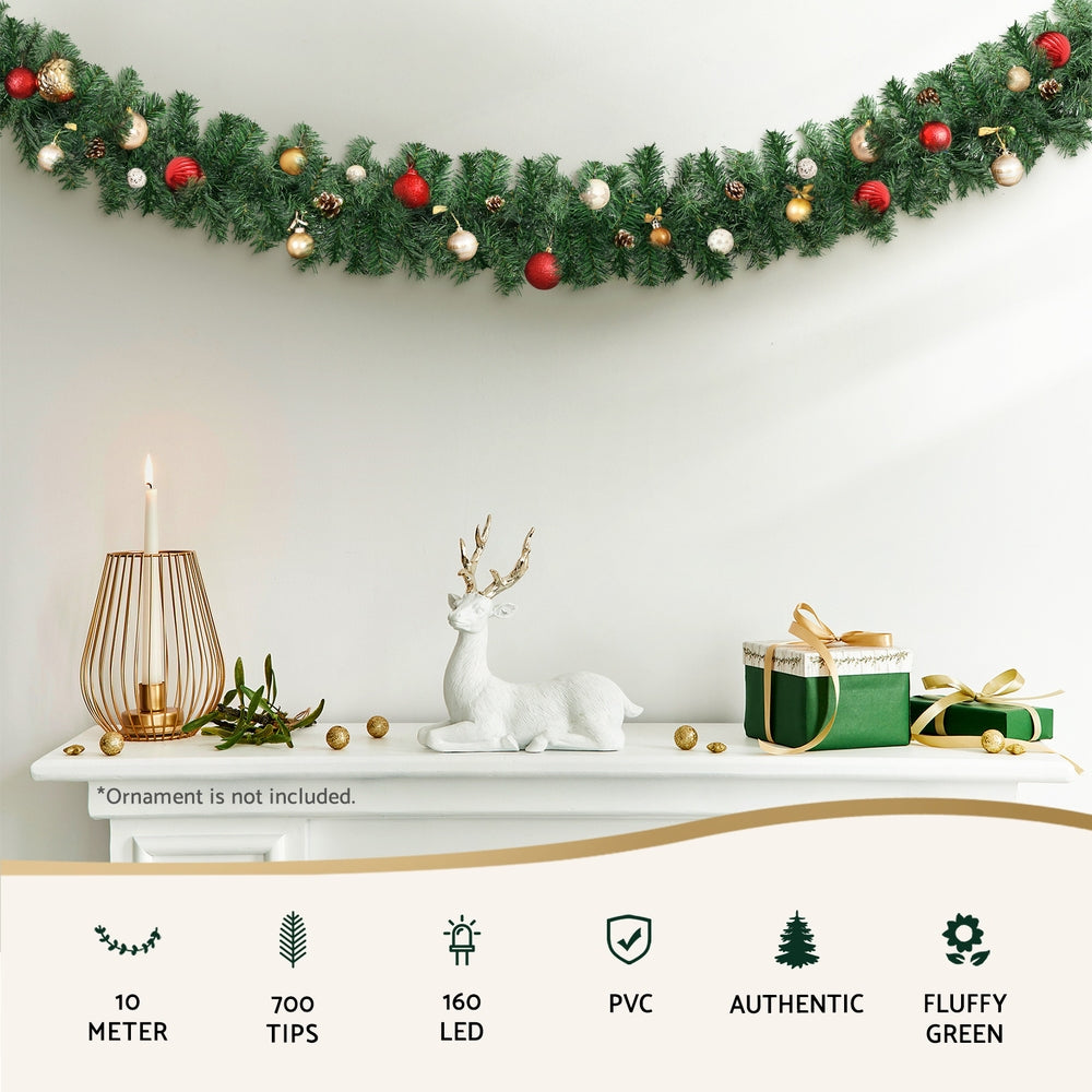 Green Christmas garland with warm white LED bulbs and hanging ornaments effect