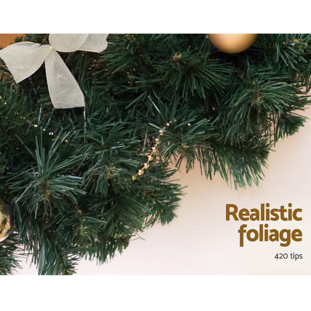 Green pine-style Christmas garland branches with warm light accents