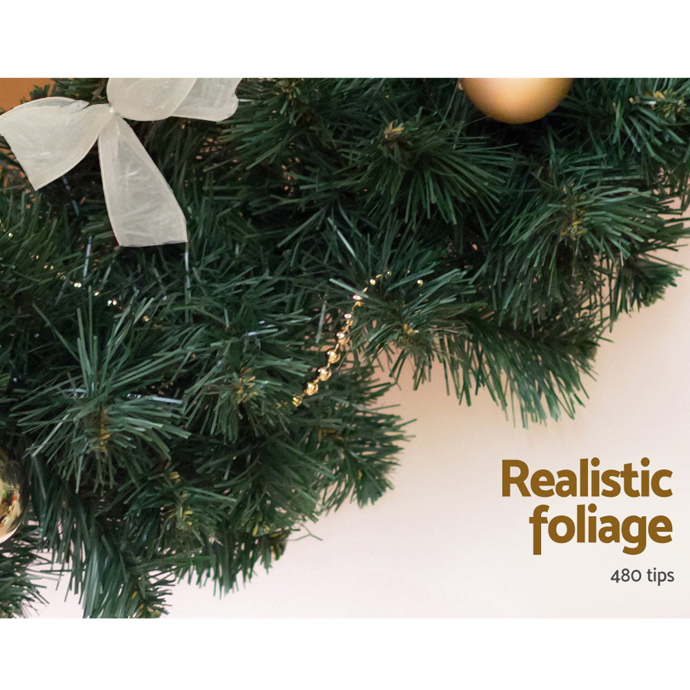 Green Christmas garland with pine tips and small gold star-like accents
