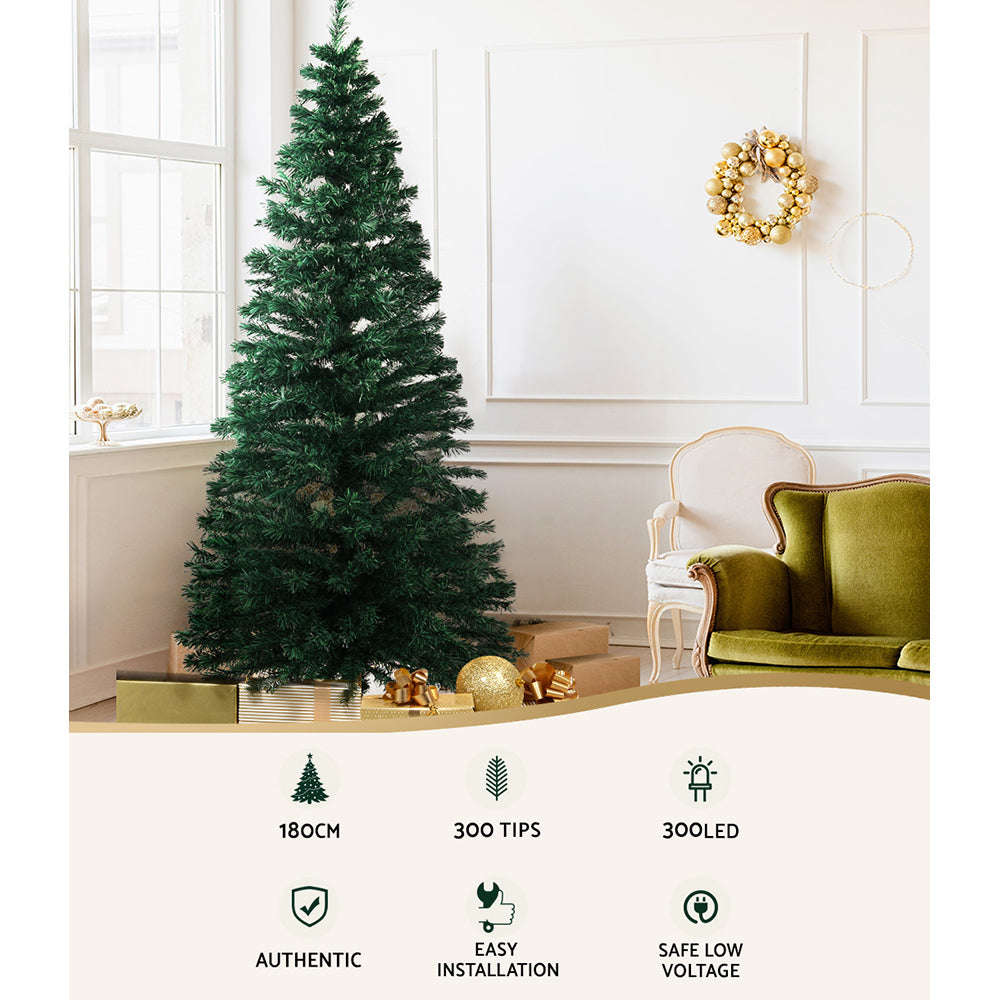 Green prelit Christmas tree with warm white optic fibre LED lights and folding stand