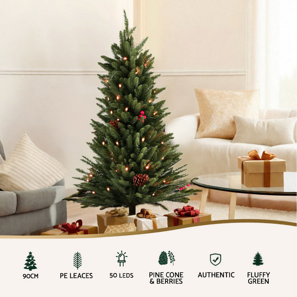 Mini Christmas tree with green branches, warm LED lights, and red-gold pinecone berry accents