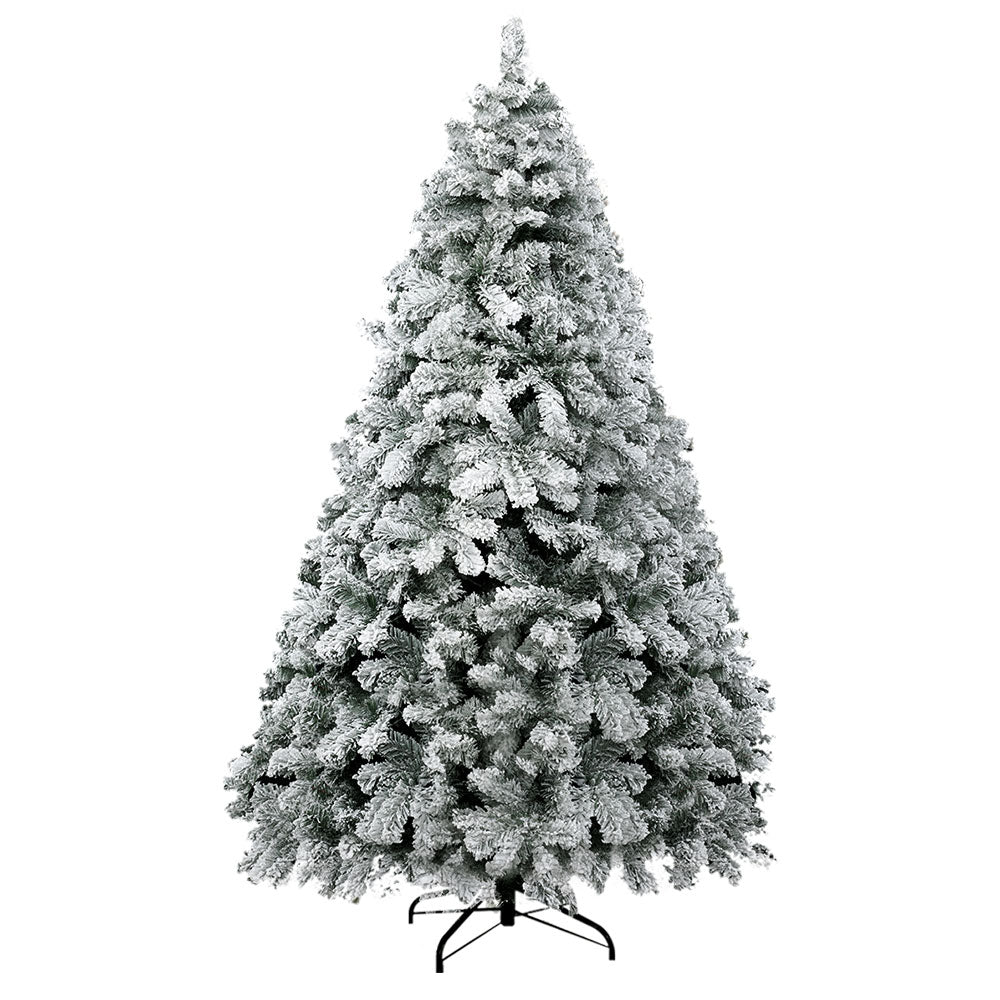 Snow flocked Christmas tree with dense, tiered branches and a pointed top