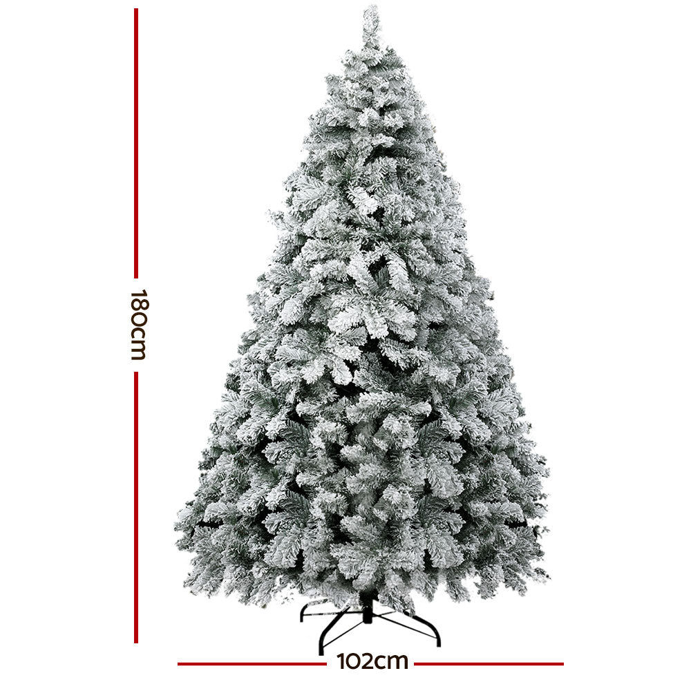 Snow flocked Christmas tree with metal stand base and full conical branches
