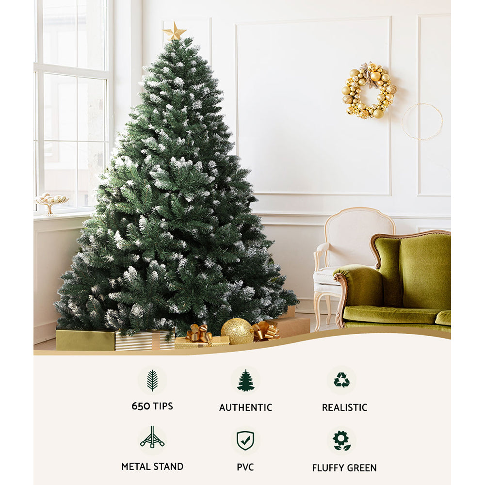 Snowy artificial Christmas tree with white-tipped branches; 650 tips and metal stand.