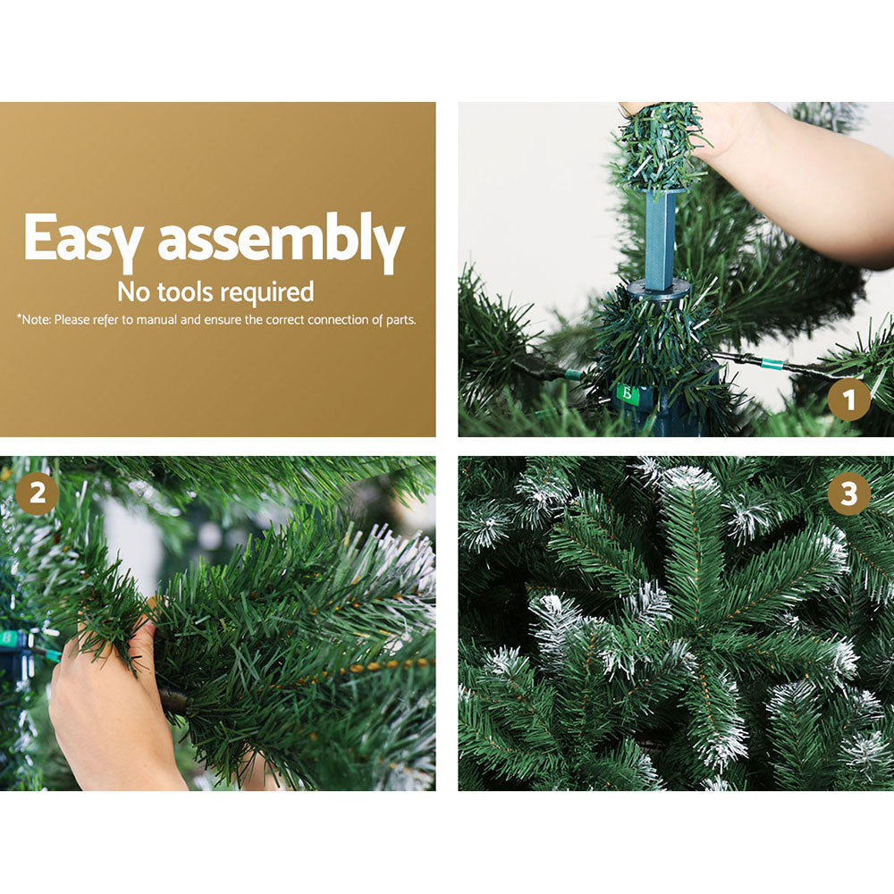 Artificial Christmas tree assembly: snowy white-tipped branches being placed on metal stand.