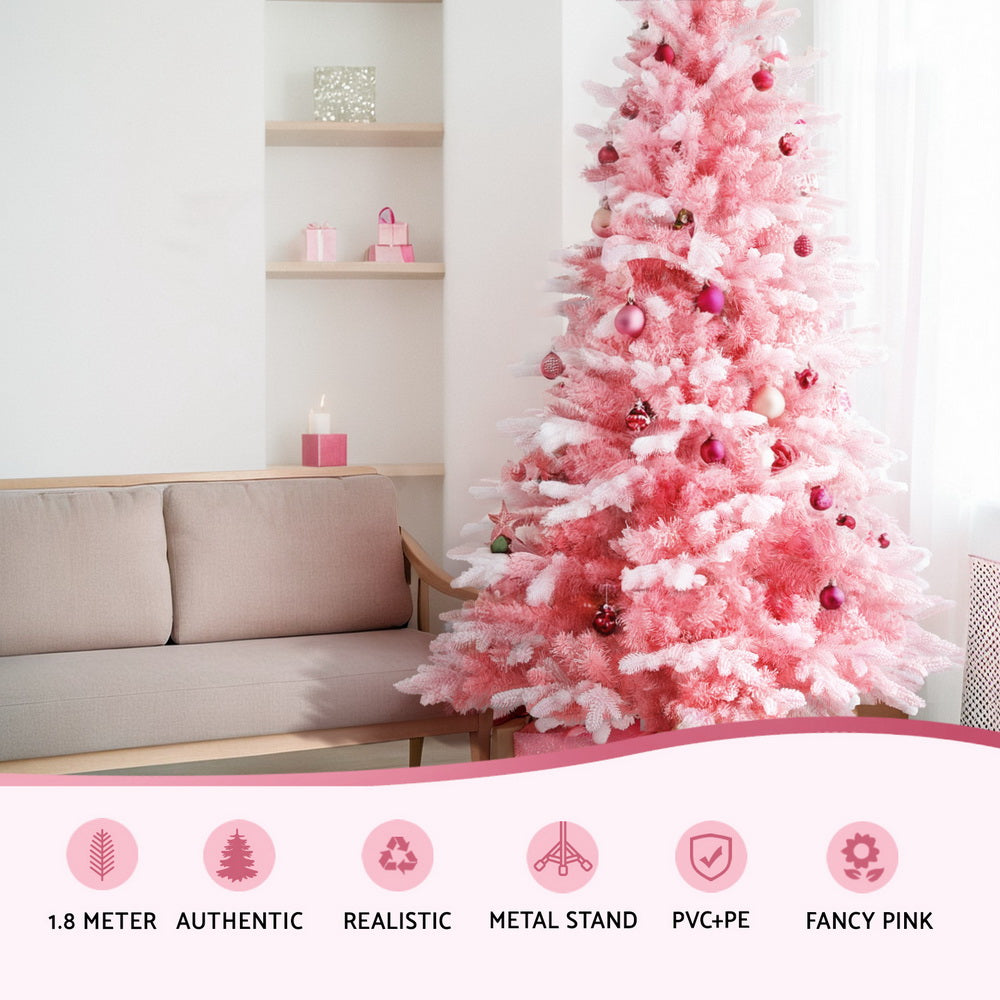 Pink snowy Christmas tree with layered branches and red-pink ornaments