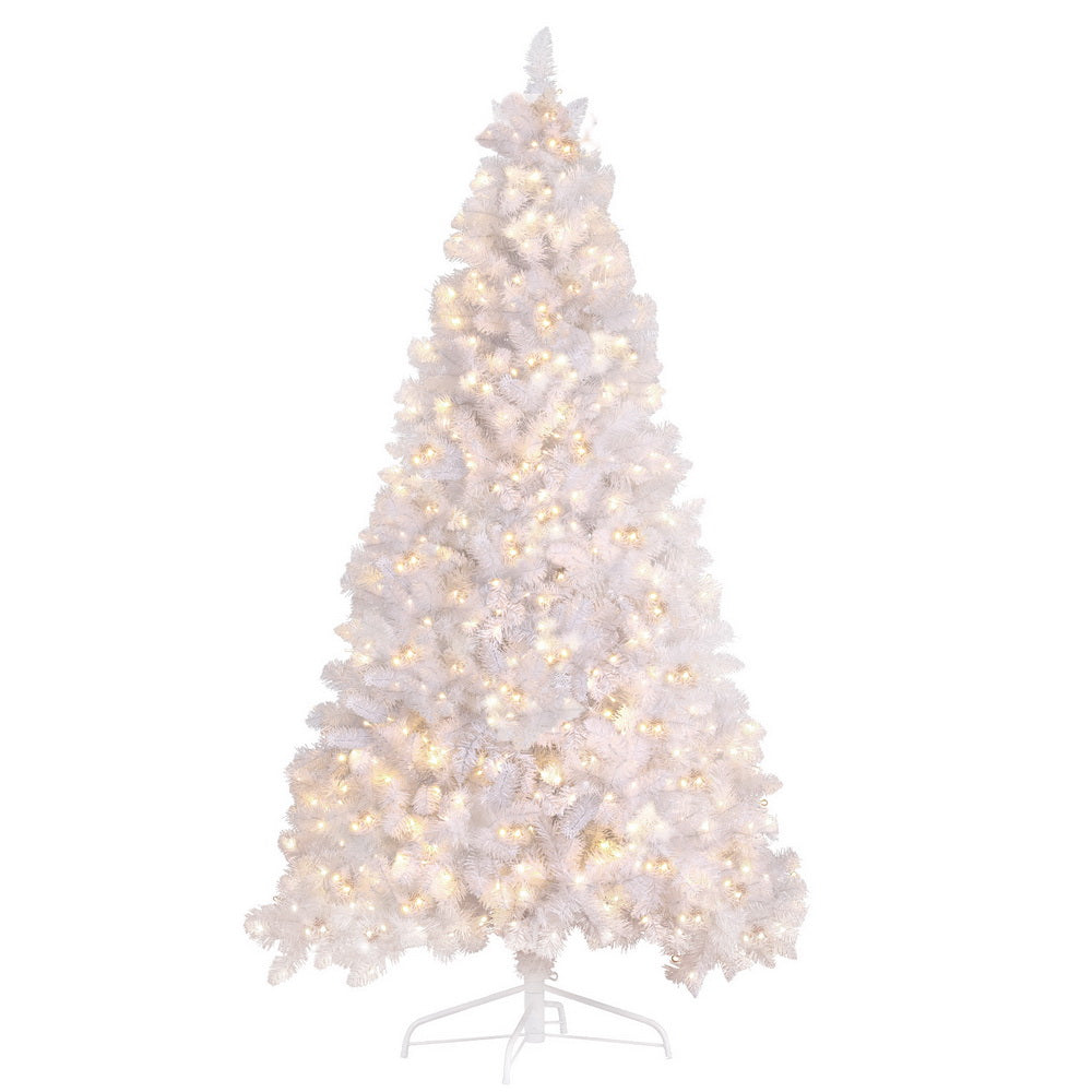 White flocked Christmas tree with warm LED lights, full conical shape