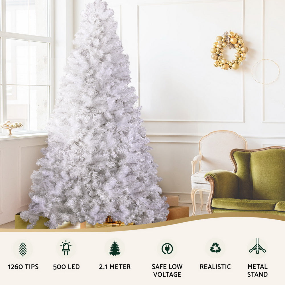 White flocked Christmas tree with warm LED lights, dense tip coverage, metal base