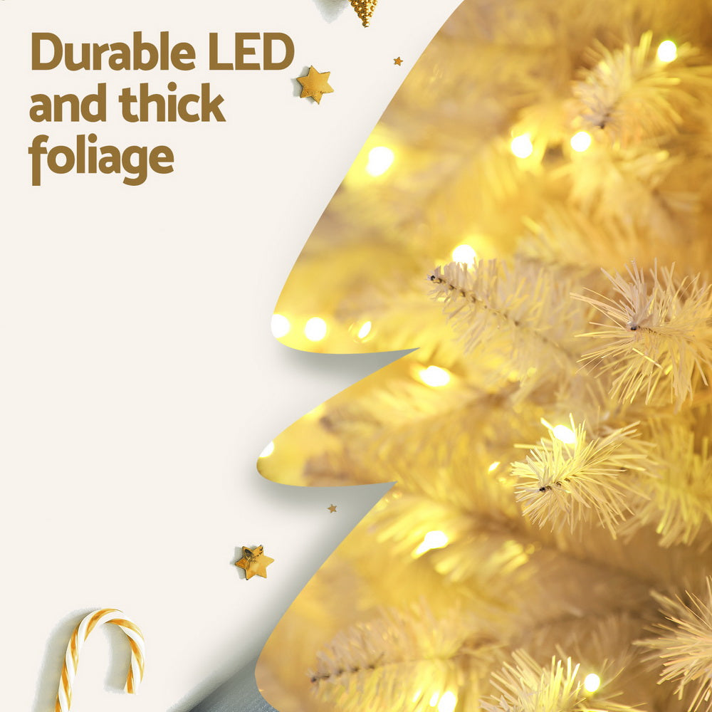 Close-up of lit artificial Christmas tree foliage with warm LED lights