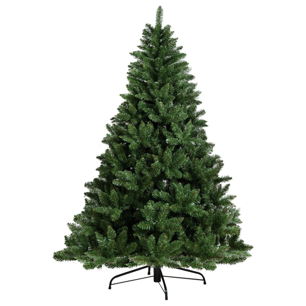 Green artificial Christmas tree with full tips and metal stand