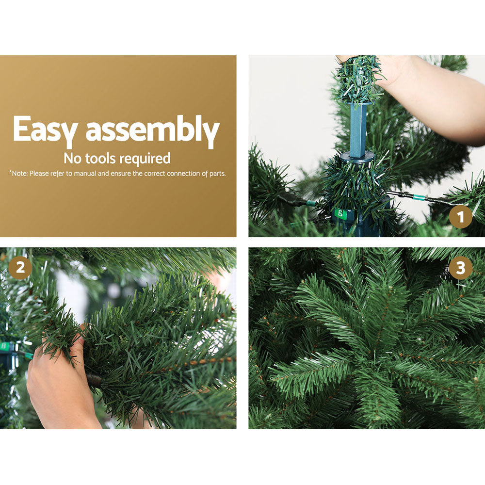 Green artificial Christmas tree during assembly with a hand attaching the stand