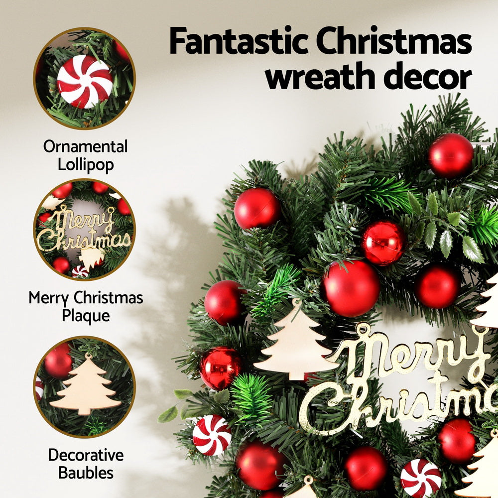 Christmas wreath decor with red baubles, candy cane accents, Merry Christmas plaque and lollipops