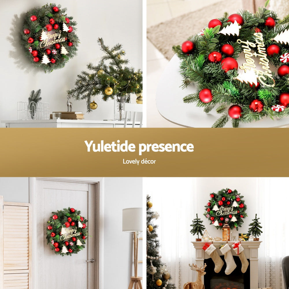 Red bauble Christmas wreath with candy cane ornaments and 'Merry Christmas' sign