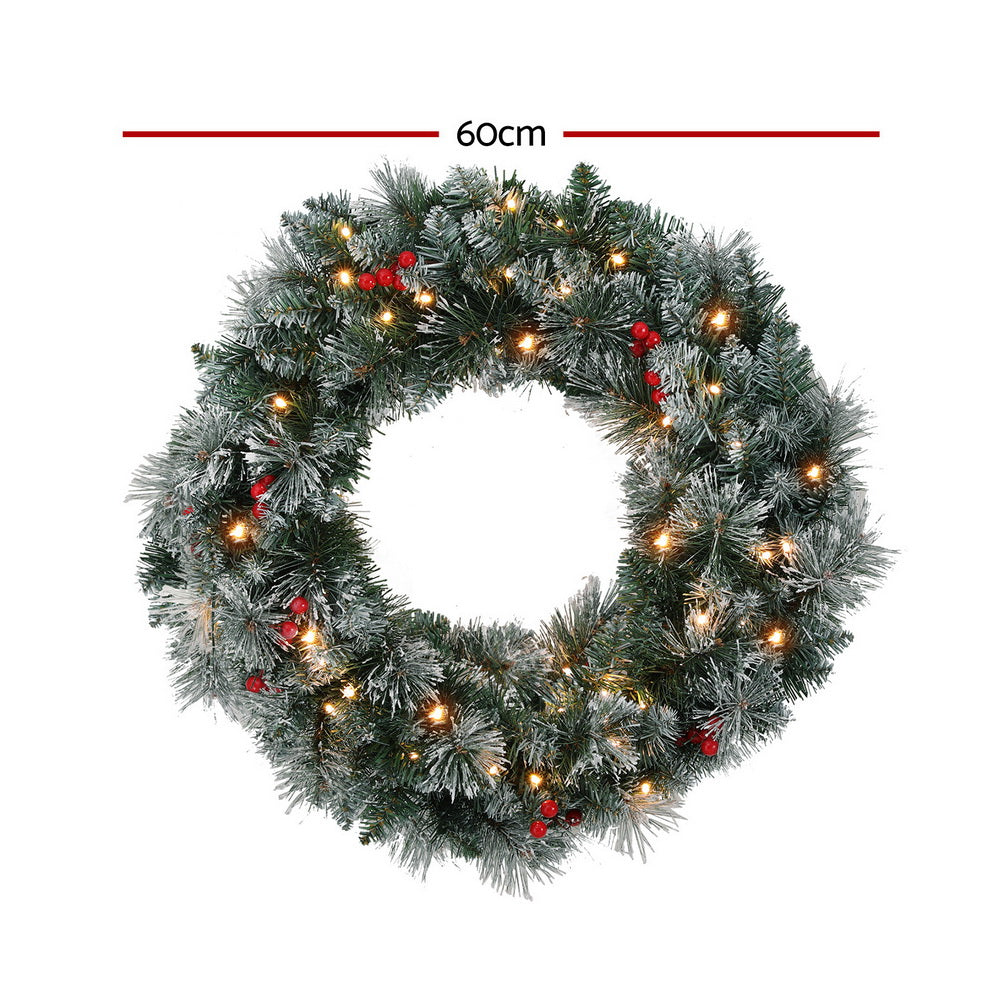 60cm snowy Christmas wreath with warm LED lights and red berry accents